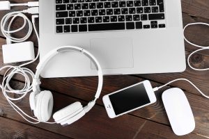 Computer peripherals and laptop accessories on wooden background