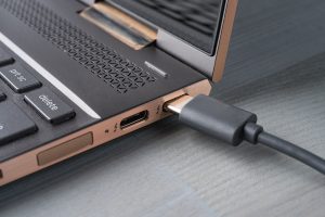 USB Type C grey cable being connected to the laptop