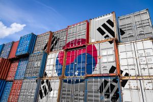 The national flag of South Korea on a large number of metal containers for storing goods stacked in rows on top of each other Conception of storage of goods by importers, exporters